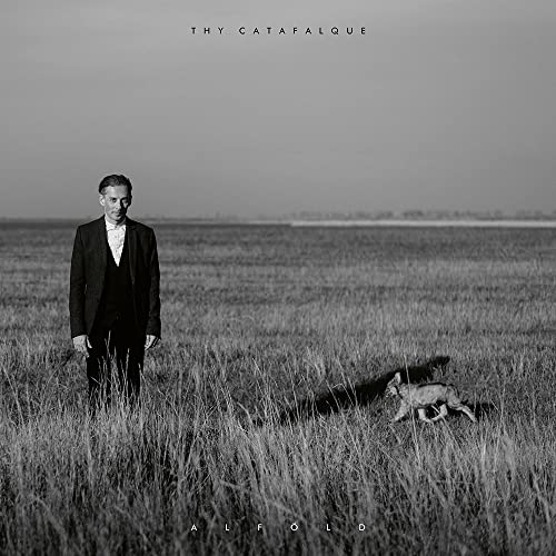 Black and white album cover: man, fox, and grassy field landscape.