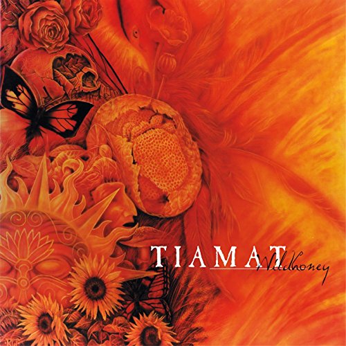 Orange album cover with a face, flowers, skull, and butterflies.