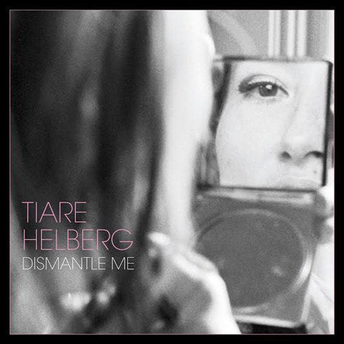 Black and white album cover featuring a woman’s eye reflected in a mirror.