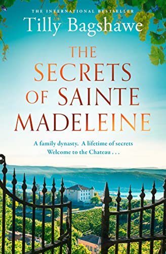 Book cover for The Secrets of Sainte Madeleine featuring a chateau beyond a gate.