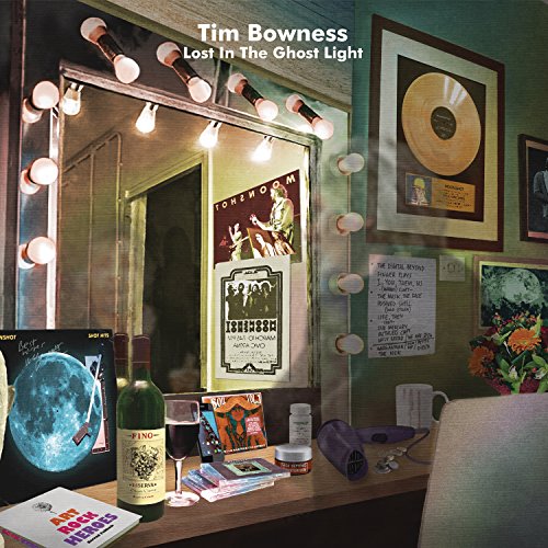 "Album cover art: dressing room with mirror, wine, and memorabilia, titled 'Lost In The Ghost Light'."