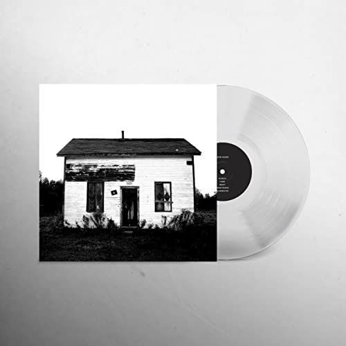 Black and white vinyl record with album cover showing a weathered cabin.