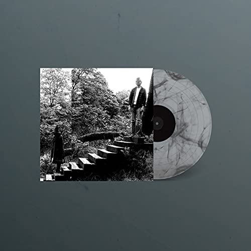 Black and white vinyl record with album art of people in a forest.