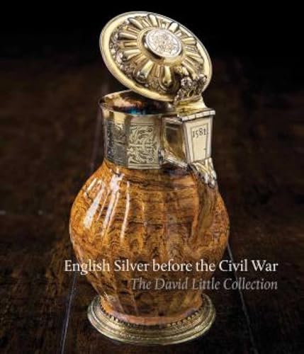Ornate silver vessel with floral details, book cover foregrounded.