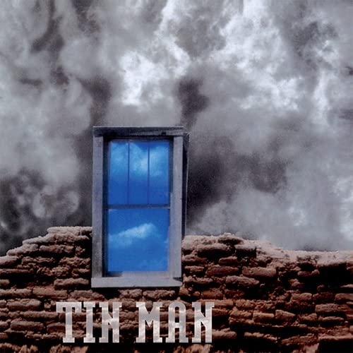 Album cover: window in stone wall against cloudy sky, text "Tin Man".