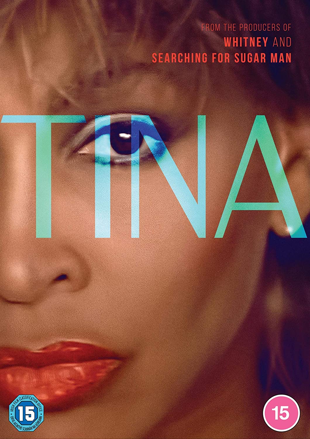 Close-up portrait of Tina Turner with the word TINA overlaid in large blue letters.