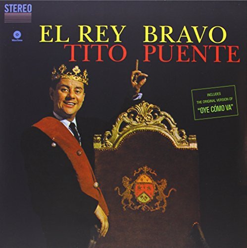Tito Puente wearing a crown and sash next to an ornate chair on album cover.