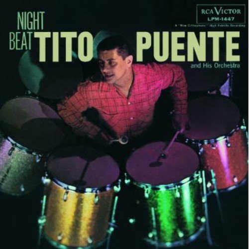 "Vinyl record cover featuring a man playing drums, titled 'Night Beat' by Tito Puente."