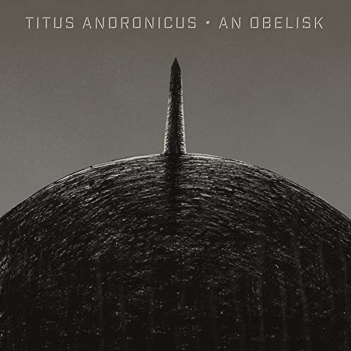 Black and white album cover featuring a textured obelisk against a sky.