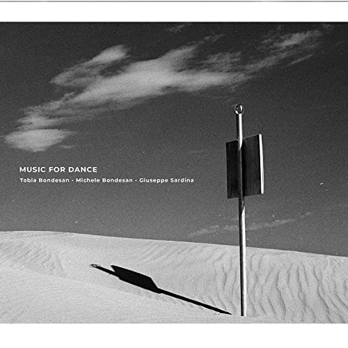CD cover: desert landscape with a flag-like structure under clouds.