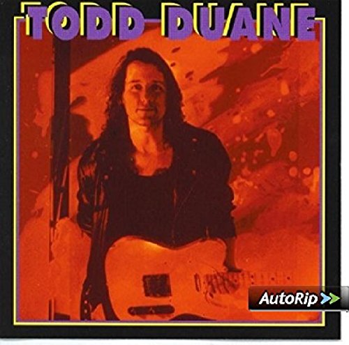 Album cover featuring Todd Duane holding an electric guitar against an orange background.
