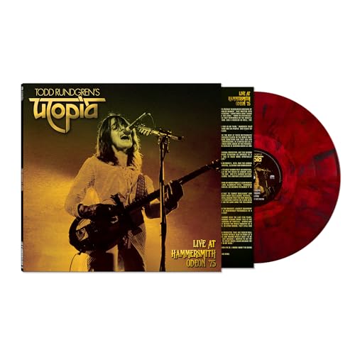 Todd Rundgren's Utopia album cover showing him performing with a red marbled vinyl disc.