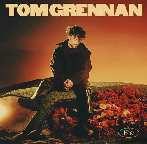 Tom Grennan album cover: portrait of a man amid flowers.
