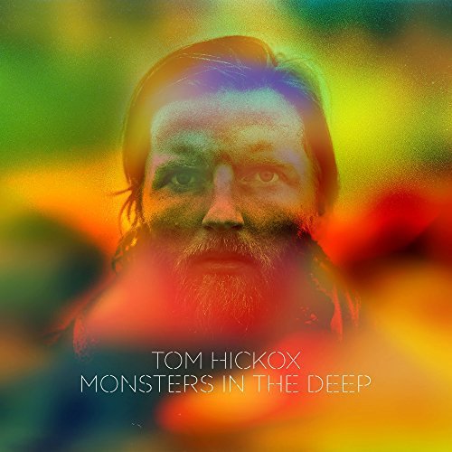 Album cover with a bearded man's face, surrounded by a rainbow-colored blurred background.