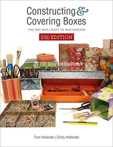 Book cover with colorful handmade boxes, tools, and crafting supplies.