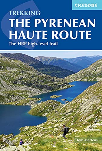 Book cover showing two hikers on a mountain trail overlooking a blue alpine lake.