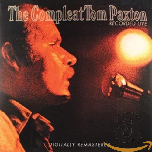 Tom Paxton singing into a microphone under a spotlight on a dark background.