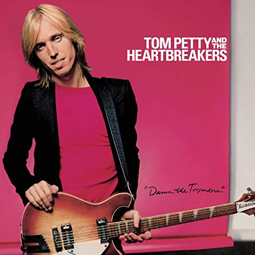Tom Petty with a guitar on the album cover for "Damn The Torpedoes".