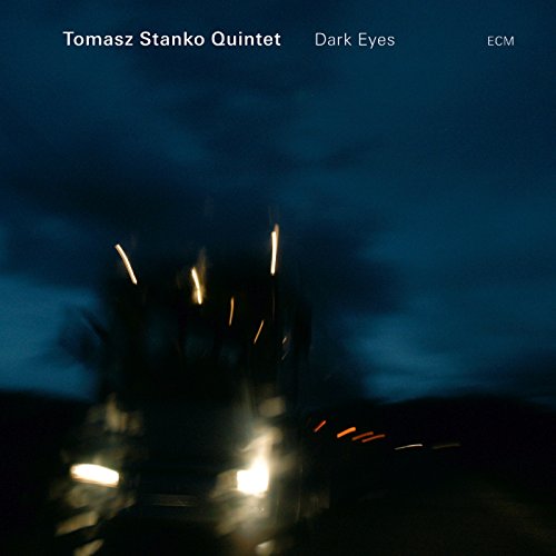 CD cover for Tomasz Stanko Quintet’s “Dark Eyes,” blurred lights at night.