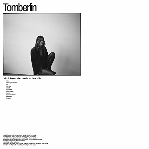 Black and white album cover featuring a person seated and looking down.