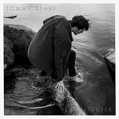 Black and white album cover featuring a man by the water.