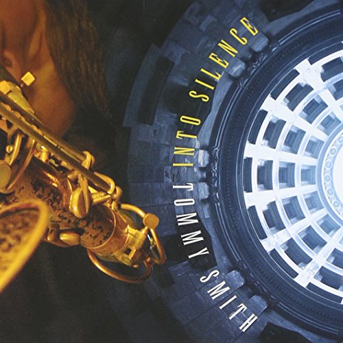 CD cover featuring a saxophone and a tire against a patterned wall.