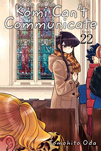 Komi stands in a church pew in front of stained glass windows.