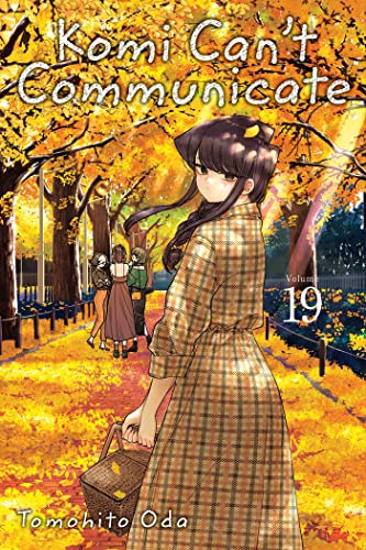 Komi in a plaid dress holding a basket amidst yellow autumn leaves and trees.