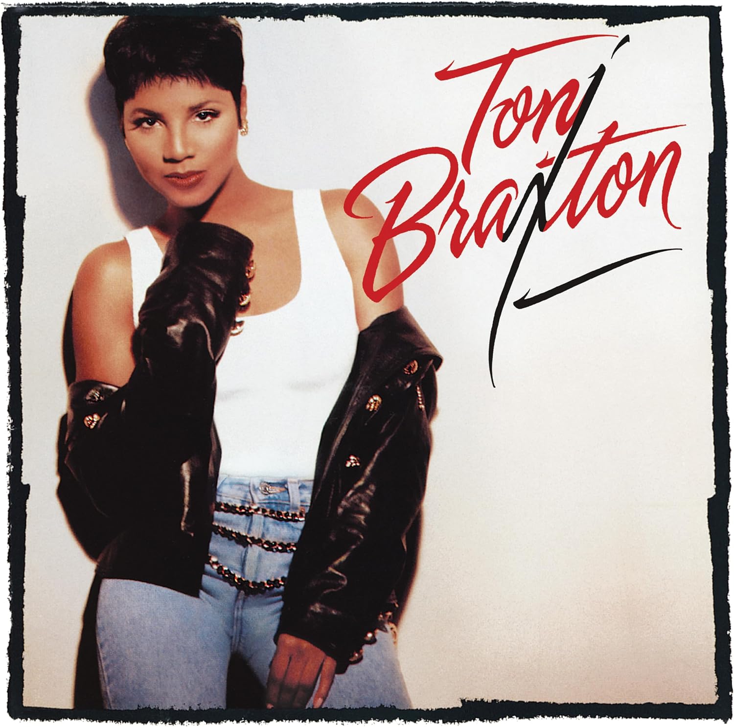 Toni Braxton album cover featuring the artist in a white tank top and leather jacket.
