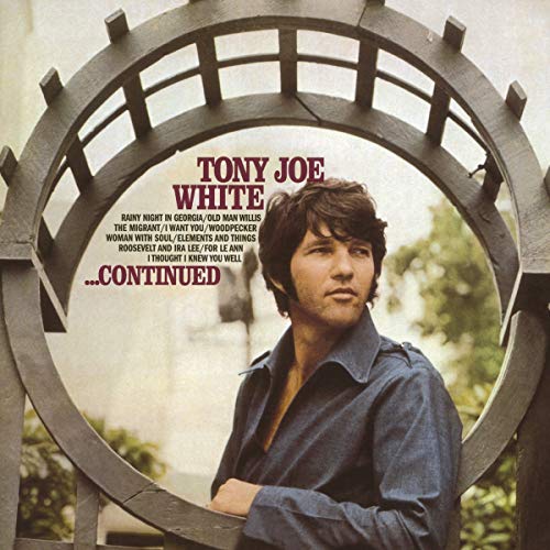 Tony Joe White stands behind a circular wooden trellis on his Continued album cover.