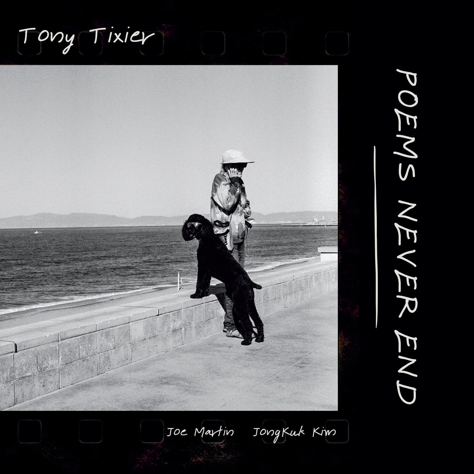 Black and white album cover featuring a person with a dog by the sea.