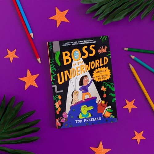 Book cover with illustrated girl and crocodile, surrounded by colorful stationery.