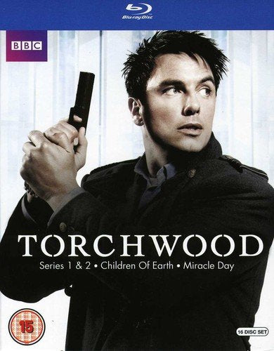 Blu-ray cover for Torchwood featuring a man holding a handgun against a white background.