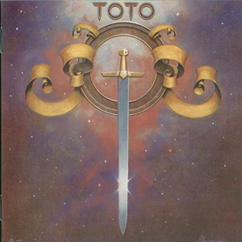 Toto album cover: sword within a golden circle on a nebula background.
