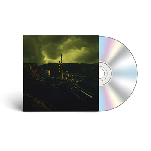 CD case with a dark, industrial landscape and reflective disc.