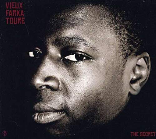 Close-up portrait of Vieux Farka Touré on a CD cover, titled "THE SECRET".