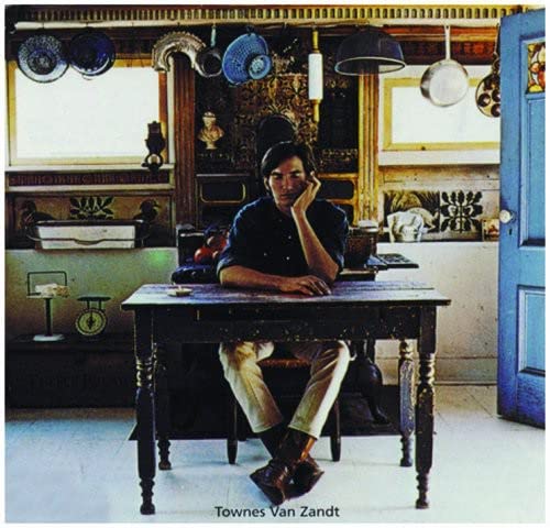 Townes Van Zandt album cover: man at a table in a room.