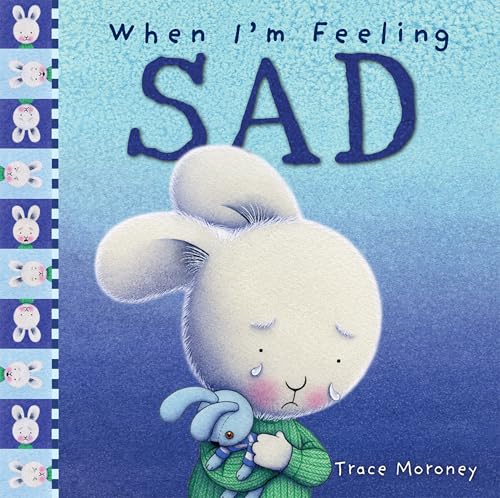 Book cover with a sad, fluffy white bunny hugging a blue toy.