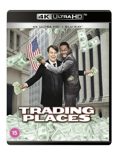 Dan Aykroyd and Eddie Murphy holding money in front of a building on Trading Places.
