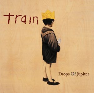 Album cover showing a child in a crown holding a bird on wood grain.