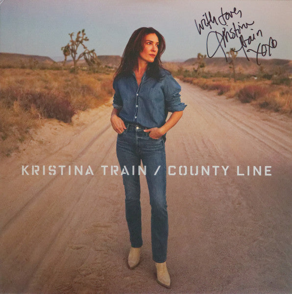 Album cover for Kristina Train’s “County Line” featuring a woman in denim.