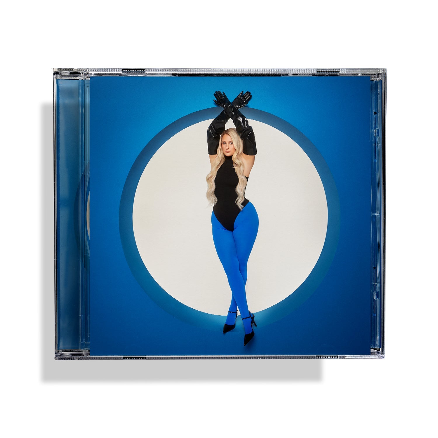 Meghan Trainor wearing a black bodysuit and blue tights inside a circular blue frame.