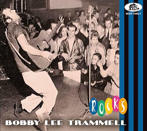 Black and white photo of Bobby Lee Trammell playing guitar onstage.