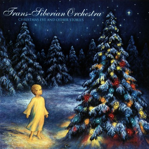 Child in pajamas looks up at a brightly lit Christmas tree.