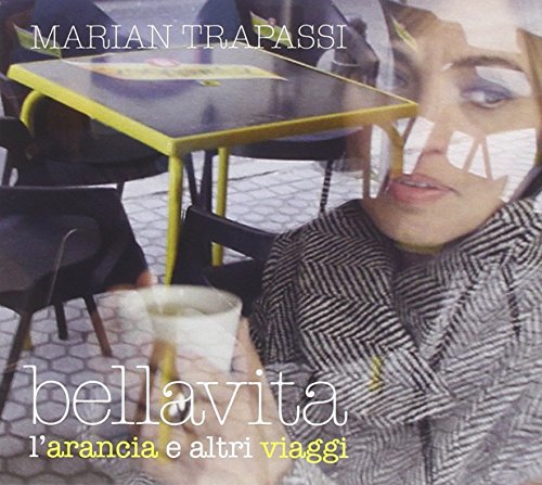 CD cover: woman at a yellow cafe table with a drink.