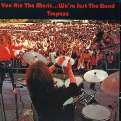 "Album cover with a band performing on stage to a large crowd."