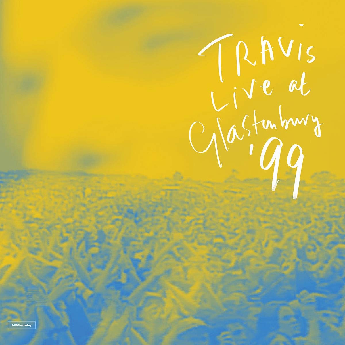 Yellow and blue abstract album cover with white text "Travis Live at Glastonbury '99".