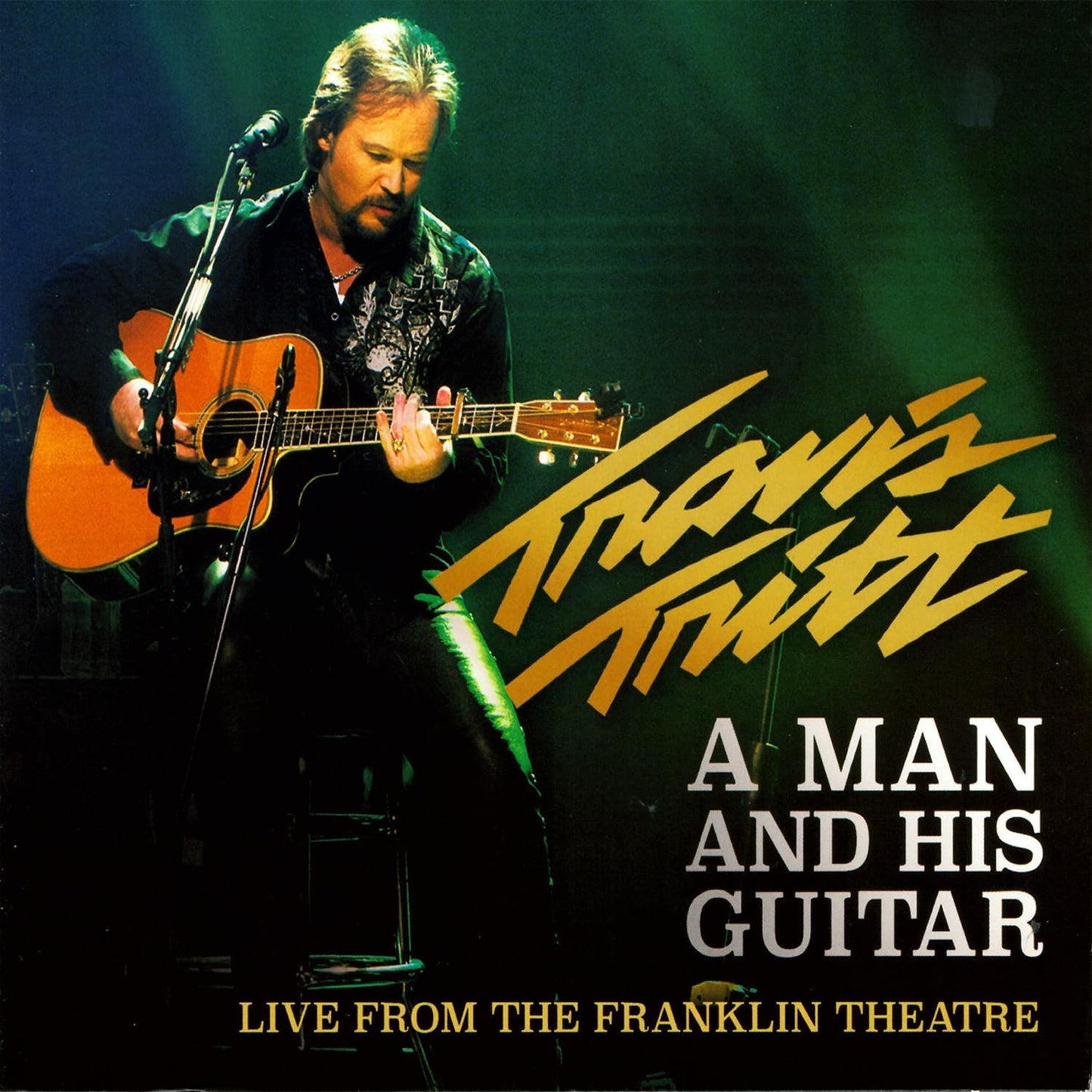 Travis Tritt CD cover, likely featuring him with a guitar, live performance imagery.
