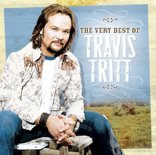 "Album cover featuring Travis Tritt sitting on a log in a field."
