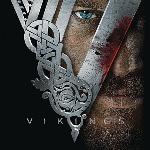A man's face partially obscured by a metallic, blood-stained V-shaped Viking emblem.